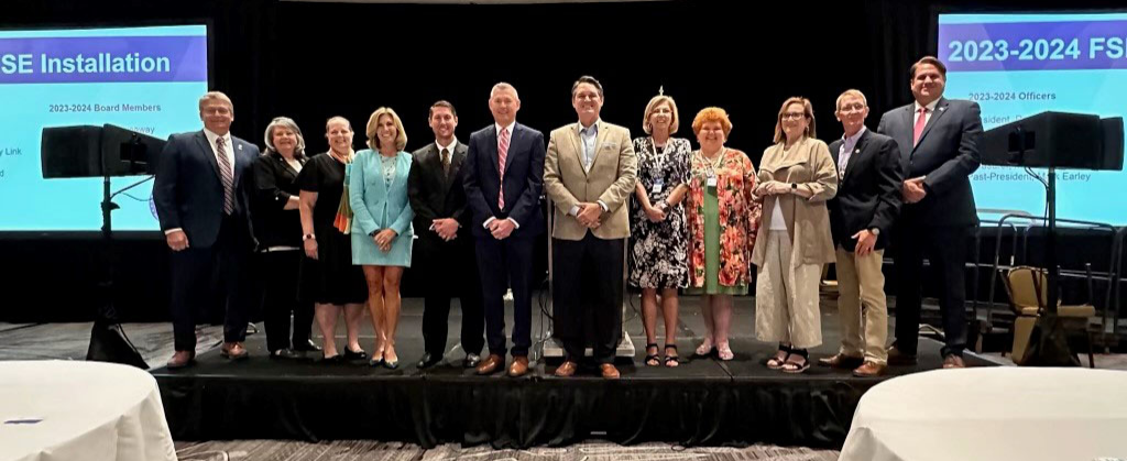 A group photo from the Florida Supervisors of Elections 2023-24 installation ceremony, including Sarasota County Supervisor of Elections Ron Turner (center left) and Florida Secretary of State Cord Byrd (center right).